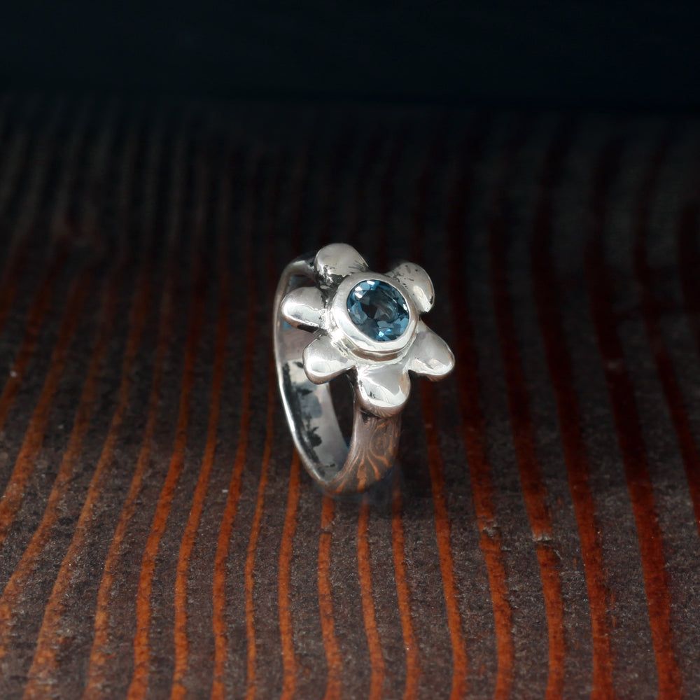 Daisy flower ring in sterling silver with London-blue topaz