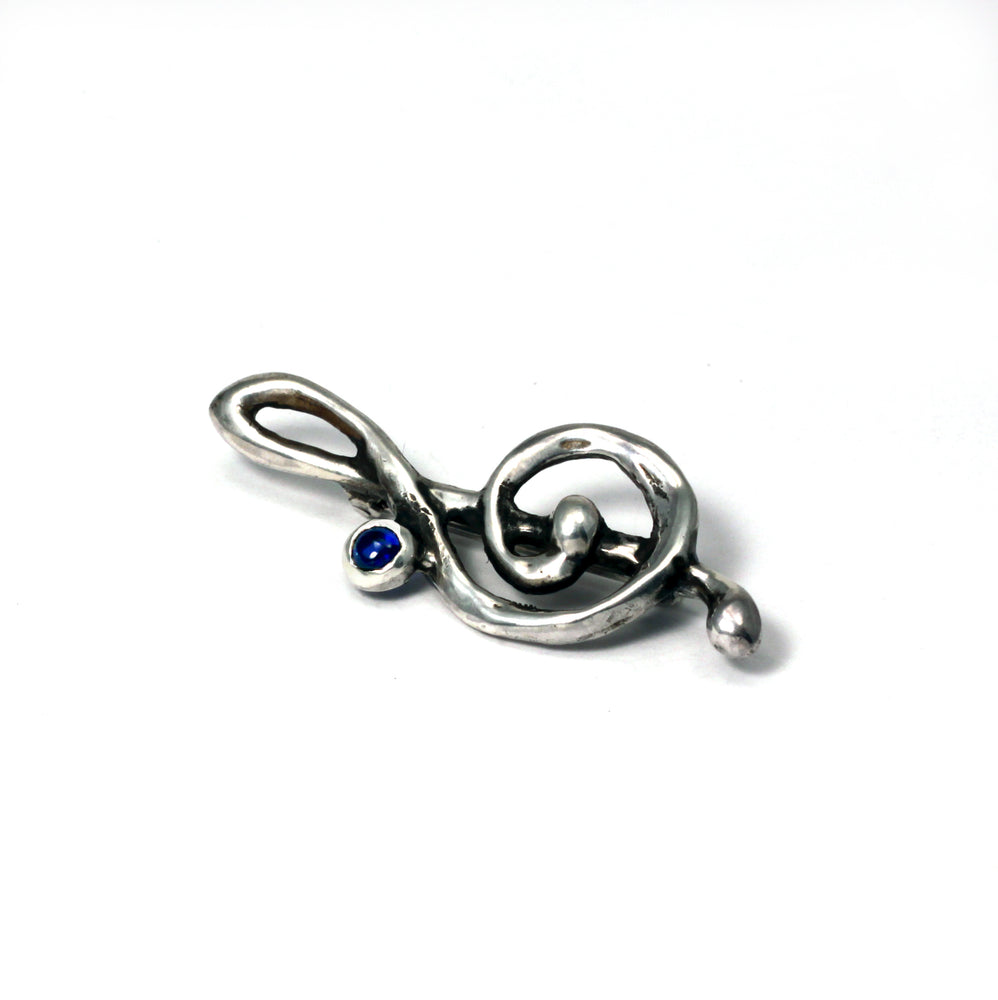 Treble Clef brooch in Sterling silver set with lab grown sapphire